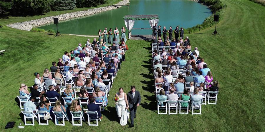 Bride and groom walking up the aisle after their outdoor wedding ceremony